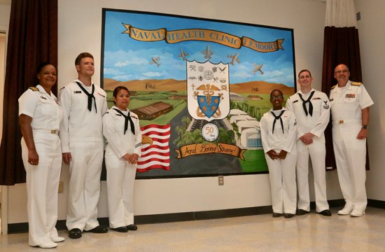 Navy Health Clinic Lemoore celebrates 50 years at Naval Air Station Lemoore Capt. Kristen Atterbury and Navy Surgeon Vice Adm. General C. Forrest Faison join the navy artist who painted a mural commemorating the 50th anniversary of the hospital/clinic Thursday morning.
